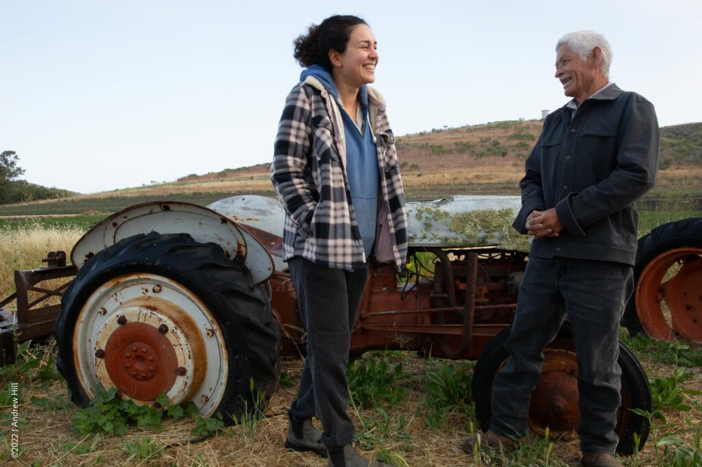 Mike and Niloofar have very different backgrounds, coming from Mexico and Iran respectively, and they share a love of farming. Here they laugh about the history of one of Mike's retired tractors.